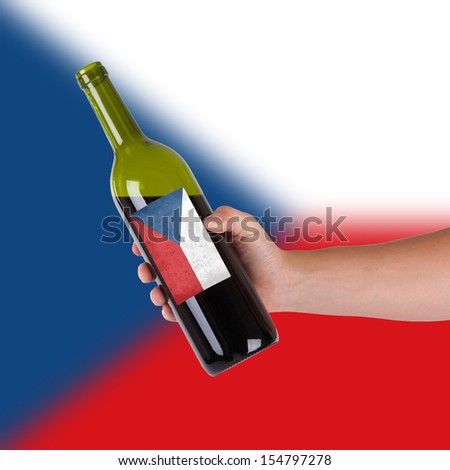Hand holding a bottle of red wine, label of Chile, isolated on white,