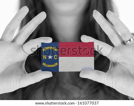 Woman showing a business card, black and white, North Carolina