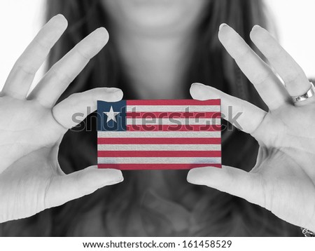 Woman showing a business card, black and white, Liberia