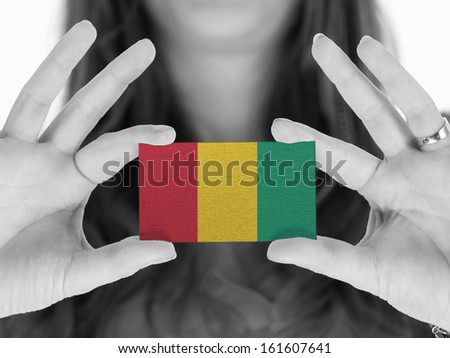 Woman showing a business card, black and white, Guinea