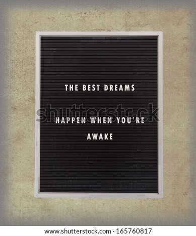 Dreams - Inspirational quotation about life on a very old menu board, vintage background