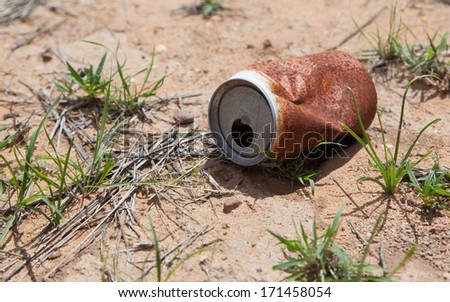 Old rusty beverage can in the Namibian desert