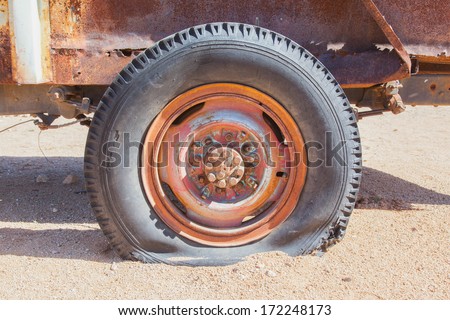 Detail of a vintage abandoned flat car tire on the side of a road, Namibia
