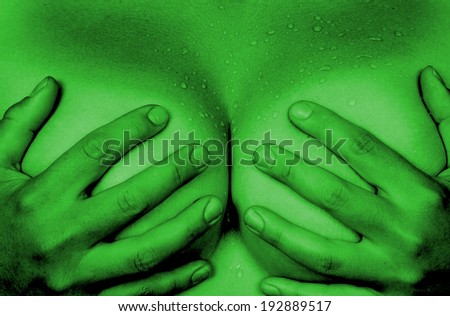 Upper part of female body, hands covering breasts, green