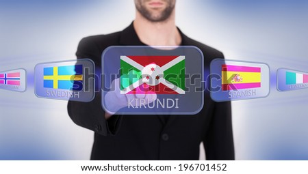 Hand pushing on a touch screen interface, choosing language or country, Burundi