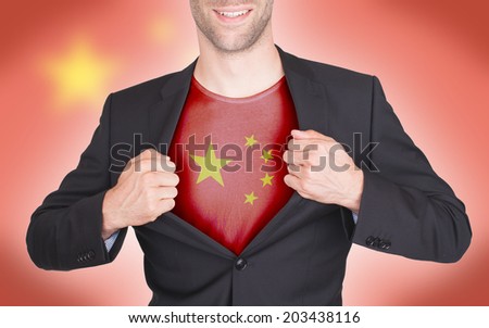 Businessman opening suit to reveal shirt with flag, China