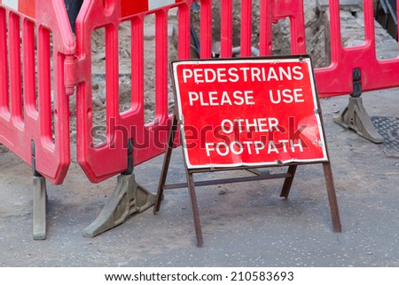 Construction sign standing on footpath, asking to use another footpath