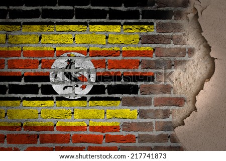 Dark brick wall texture with plaster - flag painted on wall - Uganda