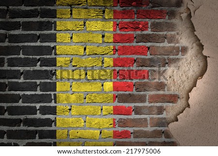Dark brick wall texture with plaster - flag painted on wall - Belgium