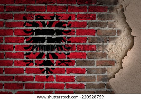 Dark brick wall texture with plaster - flag painted on wall - Albania