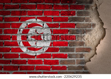 Dark brick wall texture with plaster - flag painted on wall - Tunisia