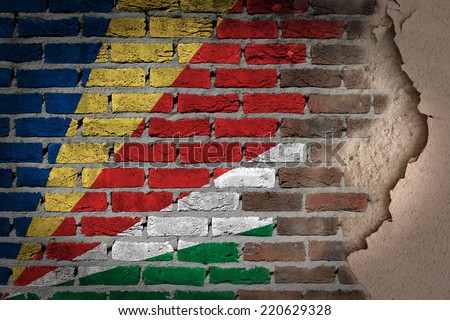 Dark brick wall texture with plaster - flag painted on wall - Seychelles