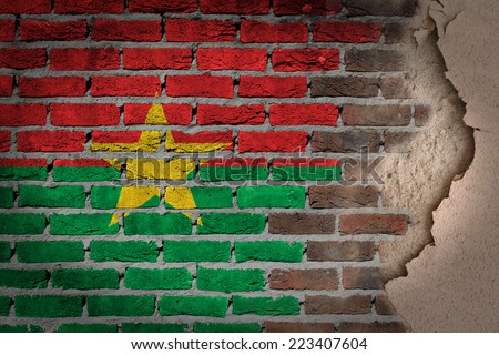 Dark brick wall texture with plaster - flag painted on wall - Burkina Faso