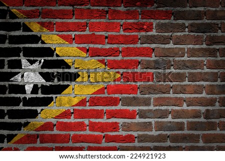 Very old dark red brick wall texture with flag - East Timor