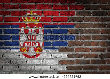 Very old dark red brick wall texture with flag - Serbia