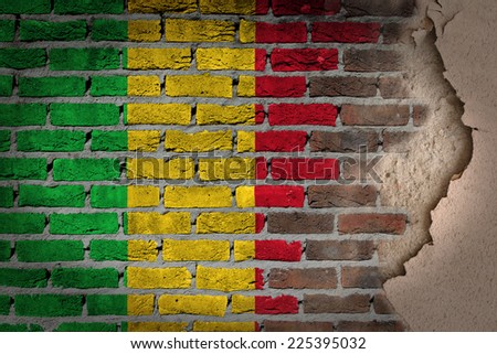 Dark brick wall texture with plaster - flag painted on wall - Mali