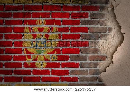 Dark brick wall texture with plaster - flag painted on wall - Montenegro