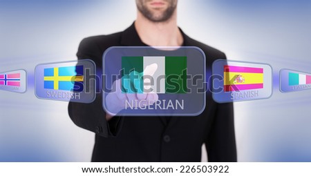 Hand pushing on a touch screen interface, choosing language or country, Nigeria