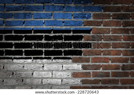 Very old dark red brick wall texture with flag - Estonia