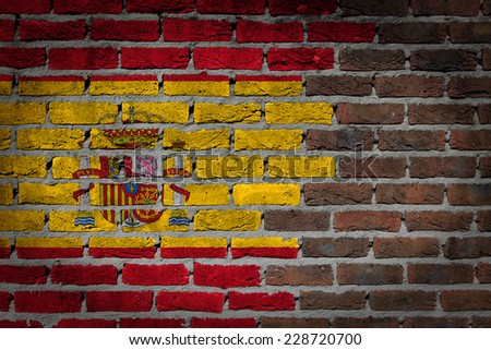 Very old dark red brick wall texture with flag - Spain