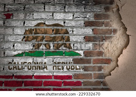 Dark brick wall texture with plaster - flag painted on wall - California