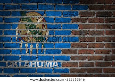 Very old dark red brick wall texture with flag - Oklahoma
