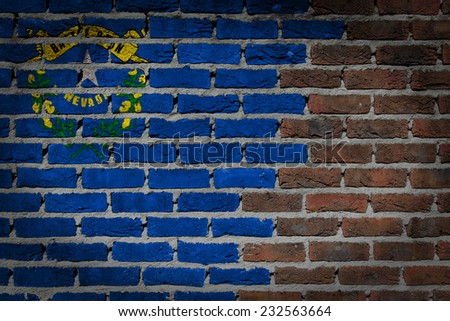 Very old dark red brick wall texture with flag - Nevada
