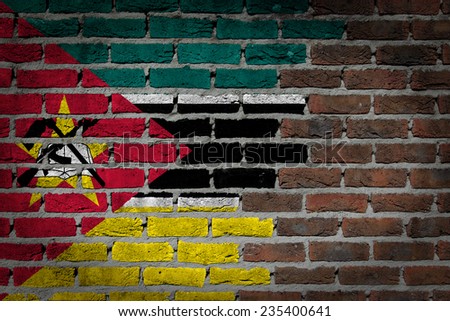 Very old dark red brick wall texture with flag - Mozambique