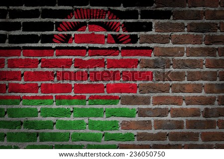 Very old dark red brick wall texture with flag - Malawi