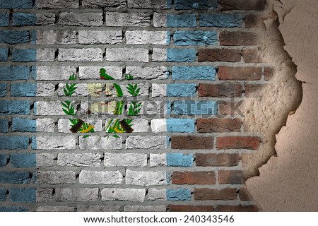 Dark brick wall texture with plaster - flag painted on wall - Guatemala
