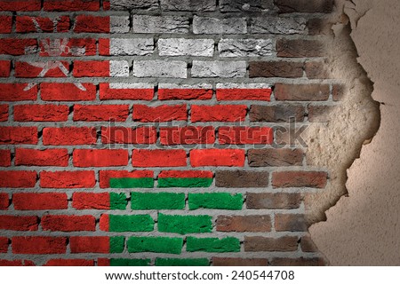 Dark brick wall texture with plaster - flag painted on wall - Oman