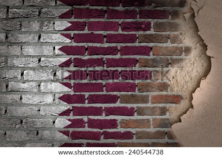 Dark brick wall texture with plaster - flag painted on wall - Qatar