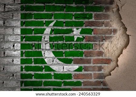 Dark brick wall texture with plaster - flag painted on wall - Pakistan