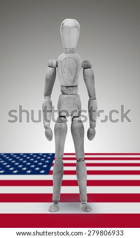 Wood figure mannequin standing on flag - USA
