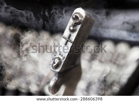 Question mark hammer for writing with an old manual typewriter - mystery smoke