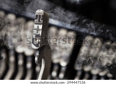 T hammer for writing with an old manual typewriter - mystery smoke