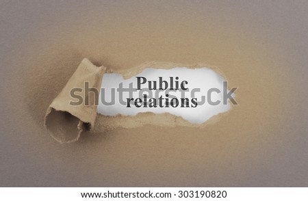 Text appearing behind torn brown envelop - Public relations