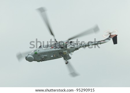 LEEUWARDEN,FRIESLAND,HOLLAND-SEPTEMBER 17: Royal Navy Helicopter Display Team \'Black Cats\' at the at the“Luchtmachtdagen” Airshow on September 17, 2011 at Leeuwarden Airfield,Friesland,Holland