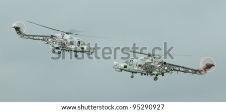 LEEUWARDEN,FRIESLAND,HOLLAND-SEPTEMBER 17: Royal Navy Helicopter Display Team \'Black Cats\' at the at the“Luchtmachtdagen” Airshow on September 17, 2011 at Leeuwarden Airfield,Friesland,Holland