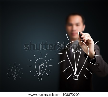 business man writing growth light bulb - development symbol of think, idea, innovation, solution, creative, vision, smart