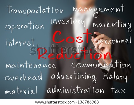 business man writing cost reduction concept