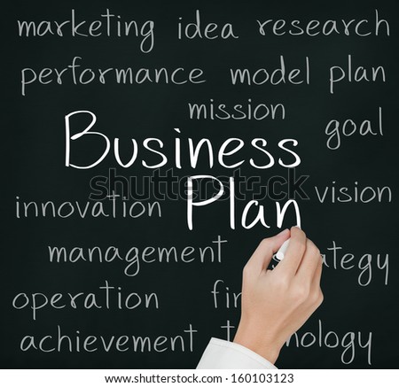 business hand writing business plan concept