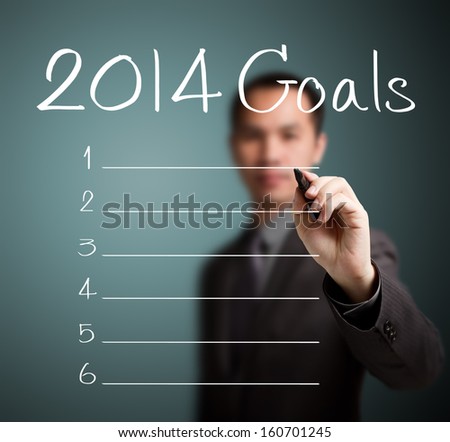 business man writing blank 2014 goals list