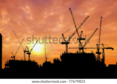 construction site silhouetted at sunset
