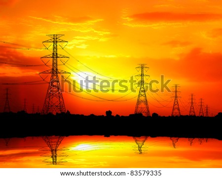silhouetted electric pylon with power line at sunset