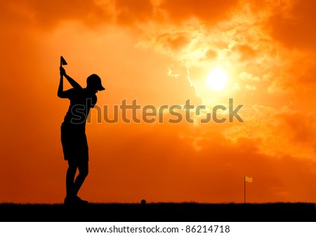 male golfer aim at golf ball at sunset silhouetted