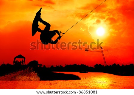 wakeboarding action man surf and jump to  beautiful sky silhouetted , extreme sport