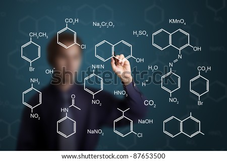 chemistry teacher writing scientific  formula of chemical on white board