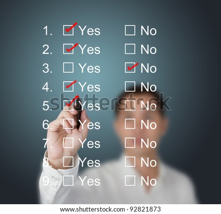 business man answering questions by make mark on yes or no boxes
