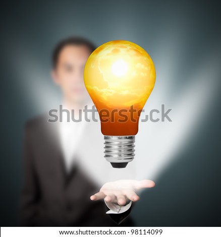 future eco - green energy concept, light bulb of solar energy in man hand